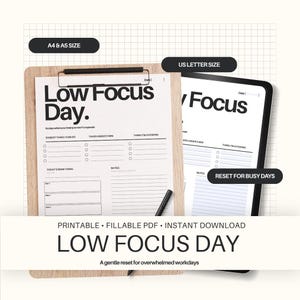 May include: A printable "Low Focus Day" planner available in A4, A5, and US Letter sizes. The design features a clipboard and a tablet with a black and white layout. Includes sections for tasks, notes, and a gentle reset for busy days.