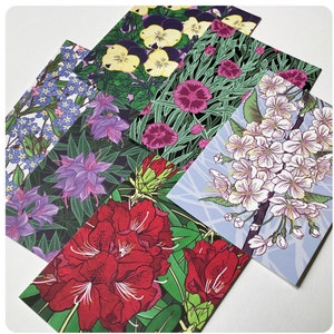 May include: Five different floral patterned greeting cards. The cards feature a variety of flowers, including pansies, rhododendrons, forget-me-nots, cherry blossoms, and carnations. The cards are printed on high-quality cardstock and are perfect for sending a special message.