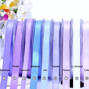 May include: Nine spools of satin ribbon in various shades of purple, blue, and white. The ribbon colors are labeled with names like Delphinium, Grape, Wisteria, Thistle, Lt. Orchid, Hyacinth, Iris, Fresco, and Lilac.