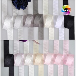 May include: Assortment of 10 colors of satin ribbon with a diamond pattern. The colors are black, white, gray, light gray, beige, pink, light pink, and two shades of blue.