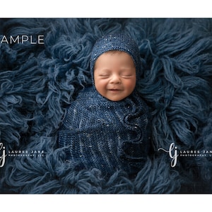 May include: A newborn baby is swaddled in a blue and white patterned blanket and wearing a blue knitted hat. The baby is lying on a blue fluffy surface. The image is labeled "SAMPLE" and "LAUREE JANE PHOTOGRAPHY, LLC".