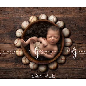 May include: A newborn baby sleeping in a wooden bowl surrounded by baseballs. The bowl is lined with brown fur. The baby is wearing a white onesie. The background is a wooden surface.
