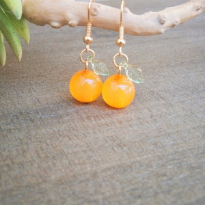 Orange earrings: Gold-plated fruit drop earrings with an orange glass bead and green leaf, also available in pumpkin shape