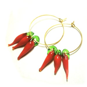 May include: Gold hoop earrings with red and green glass chili pepper charms.