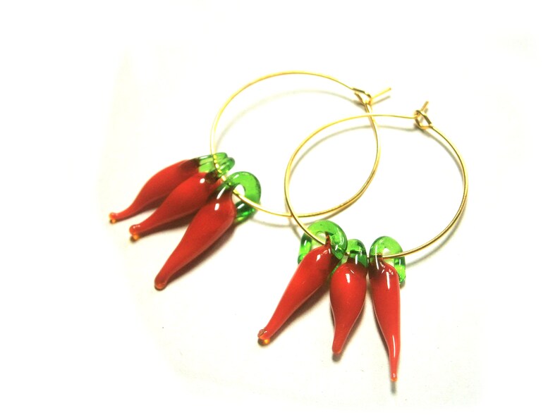 May include: Gold hoop earrings with red and green glass chili pepper charms.