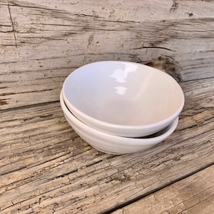 Pair of hand made 6” bowls. White glaze over hand made ridged body.18-20 and 21-20