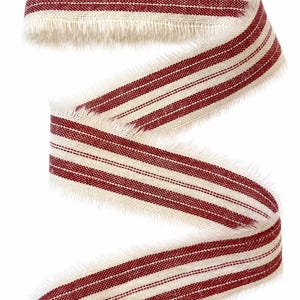 May include: A length of woven fabric ribbon featuring a repeating pattern of deep red stripes against a natural beige background. The ribbon has a distinct frayed, raw edge texture along both sides and is arranged in a loose, winding S-shape.