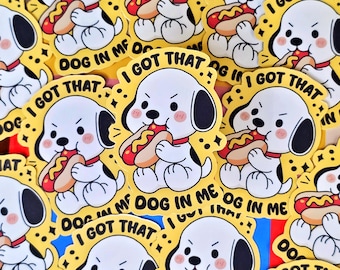 May include: A collection of yellow stickers featuring a cartoon dog eating a hot dog. The dog is white with black ears and spots, wearing a red collar. Text on the stickers reads "I GOT THAT" and "DOG IN ME".