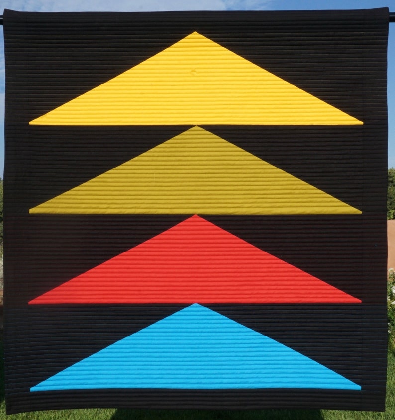 May include: A black background with four triangles layered on top of each other. The top triangle is yellow, the second is gold, the third is red, and the bottom is blue.