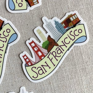 A couple illustrated San Francisco vinyl stickers, scattered on a neutral background.