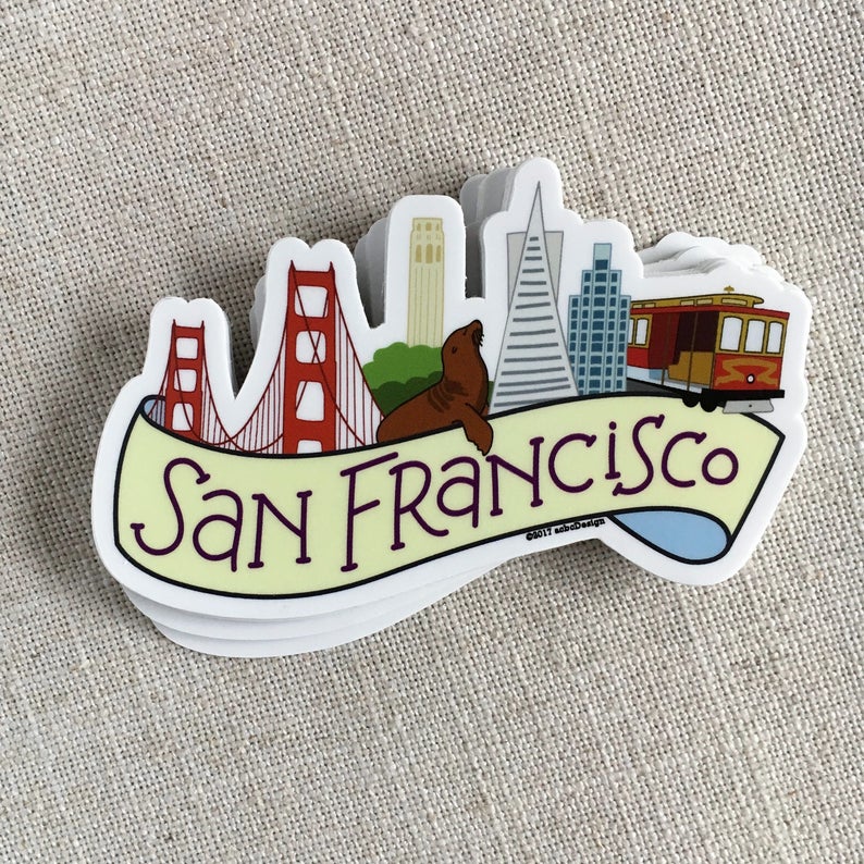 A stack of illustrated San Francisco vinyl stickers, on a neutral background.