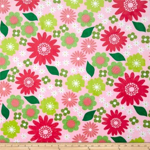 May include: Pink fabric with a repeating pattern of red, green, and white flowers. The flowers are stylized and have a retro look.