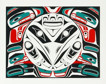 May include: A black and white print of a Native American design featuring a stylized creature with red, teal, and white accents. The design is framed by a black border.