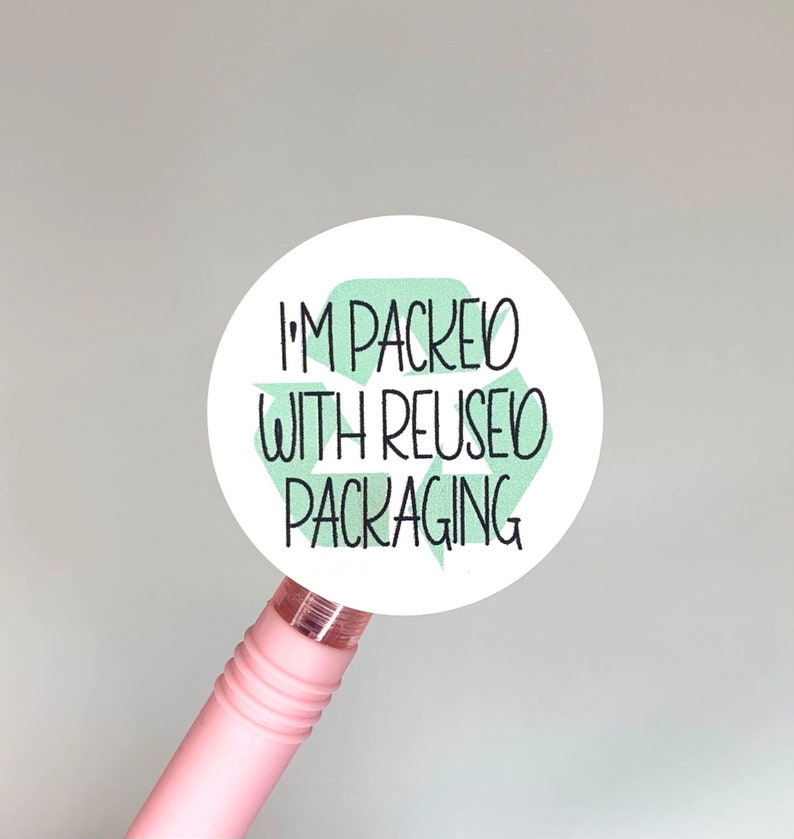 May include: A white round sticker with a green recycling symbol and the text "I'm packed with reused packaging".