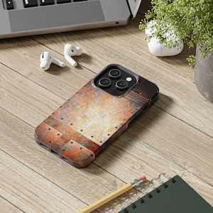 May include: A phone case with a rusty metal design. The case is made of a hard plastic material and has a raised camera bump. The case is designed to fit an iPhone 13 Pro Max.