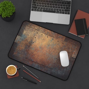 May include: A brown and black mouse pad with a metallic texture and a white computer mouse on top. The mouse pad is on a black surface with a cup of coffee, pencils, and a pen.