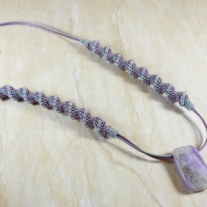 Mauve and grey glass beads necklace with an agate pendant. Cellini spiral stitch.