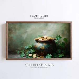 May include: A framed digital art print featuring a pot of gold overflowing with coins, surrounded by green shamrocks. The artwork has a vintage style with a green and gold color palette. The text "FRAME TV ART" and "STILLHOUSE PRINTS" are visible.