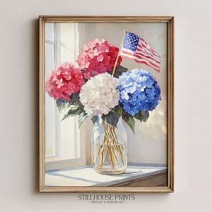 May include: A framed painting of a floral arrangement in a glass jar. The bouquet features red, white, and blue hydrangeas, with an American flag. The artwork is displayed on a windowsill, with the text "STILLHOUSE PRINTS VINTAGE & MODERN ART" at the bottom.