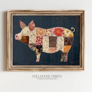 May include: A framed wall art print featuring a pig silhouette composed of various floral and textured fabric-style patches in shades of cream, brown, red, and orange, accented with a pink snout and a red flower, set against a dark navy blue background.