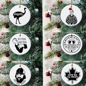 May include: Set of six round white ceramic ornaments with black and white illustrations. The ornaments feature a cartoon emu, a man in a plaid shirt and Santa hat, a man holding a newspaper, a tavern logo, a man with a beard and a baseball cap, and a maple leaf with text.