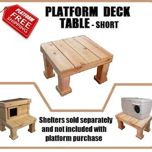 May include: A square wooden platform deck table with four sturdy legs. The text reads PLATFORM DECK TABLE - SHORT. Two additional images show the platform supporting a wooden shelter and a plastic container. Text states shelters are sold separately.