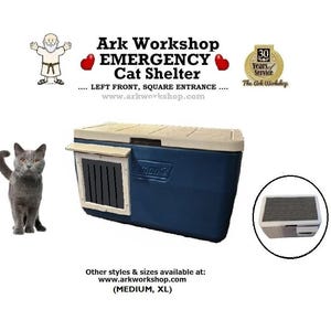 May include: A navy blue and tan cat shelter with a square entrance. The shelter has the text "Ark Workshop EMERGENCY Cat Shelter" and a small illustration of a cat. The shelter is designed for emergency use.