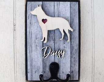 May include: Wooden dog leash hook with a gray and white woodgrain finish. The hook features a cutout of a dog with a heart on its chest and the name "Daisy" written below.