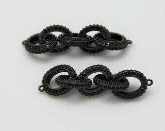 May include: Two black chain link connectors with small black rhinestones. The connectors are made of metal and have a shiny finish.