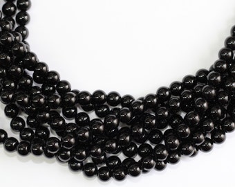 May include: A strand of black onyx beads, with a smooth, polished finish. The beads are round and uniform in size, creating a classic and elegant look.