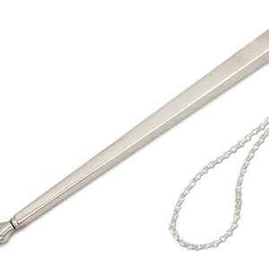 May include: A silver yad, a Jewish religious pointer used for reading the Torah, with a chain attached to the top.