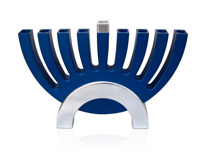 May include: A blue and silver menorah with nine candle holders. The menorah is shaped like a half-circle with a silver base.