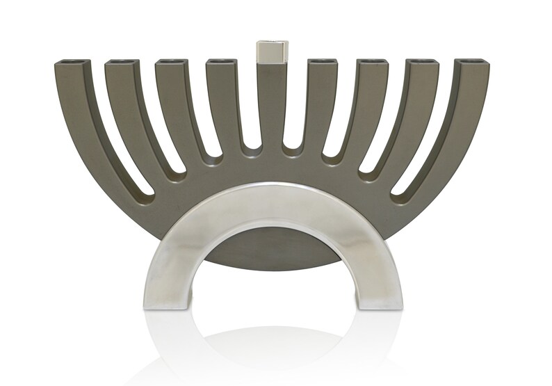 May include: A silver and gray menorah with nine candle holders. The menorah is shaped like a half-circle with a silver base.