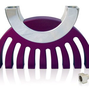 May include: A purple and silver menorah with a modern design. The menorah has nine candle holders and a curved base.