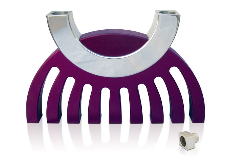 May include: A purple and silver menorah with a modern design. The menorah has nine candle holders and a curved base.