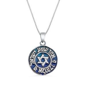 May include: A silver necklace with a blue enamel pendant featuring a Star of David and Hebrew text. The pendant is round and has a blue and white gradient.