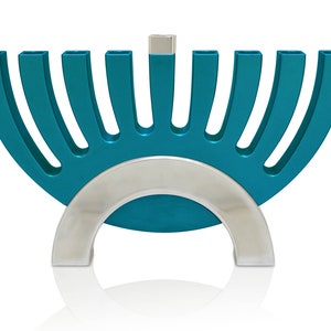 May include: A teal blue menorah with a silver base and nine candle holders. The menorah is shaped like a half-circle.