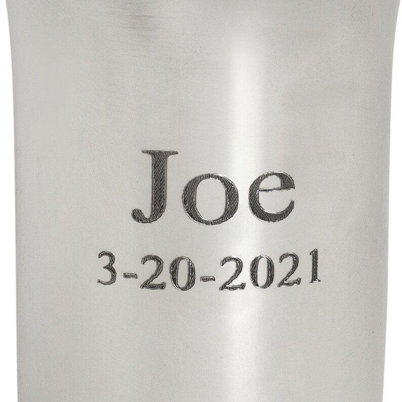 May include: A silver cup with the name "Joe" and the date "3-20-2021" engraved on it.
