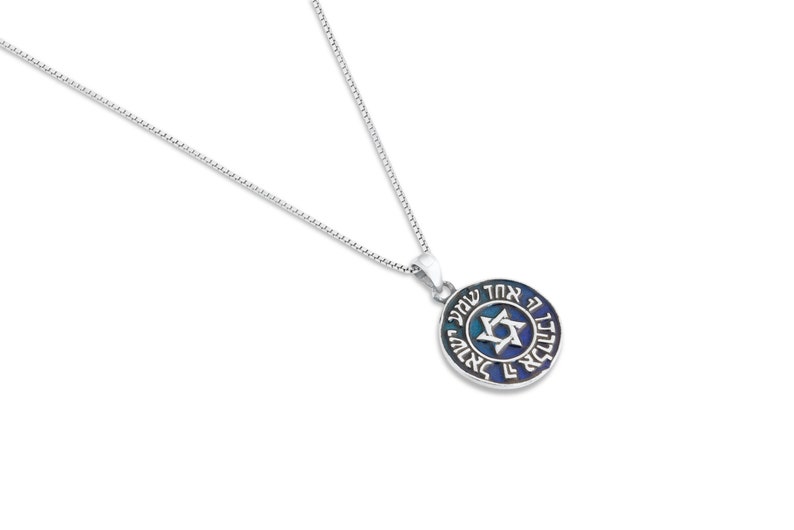 May include: A silver chain necklace with a round pendant featuring a blue and green enamel Star of David with Hebrew text around the edge.