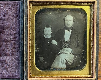 Sweet father and son portrait. Sixth plate daguerreotype in split case. Wipe marks.