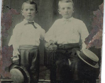 Tintype of two little boys holding hats