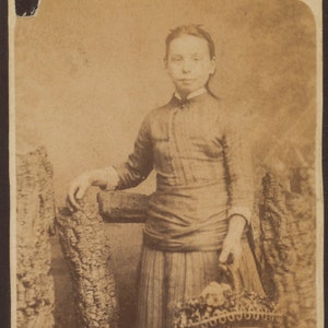 CDV of girl holding a basket of flowers/ carte de visite