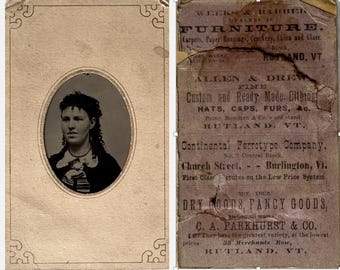 Tintype of a woman in paper frame with advertisements