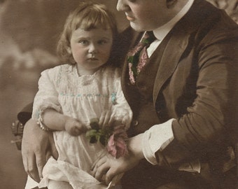 Hand colored photo postcard of father and daughter. RPPC. Real photo postcard