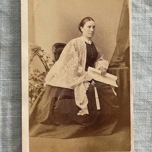 CDV/ carte de visite of a scholarly lady holding a fan and a document or sheet music. Identified.