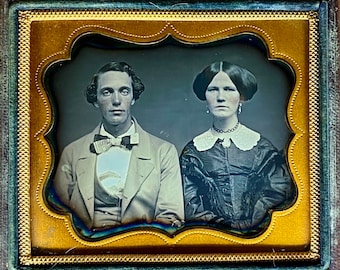 Horizontal sixth plate daguerreotype of a couple. Complete scarce case.