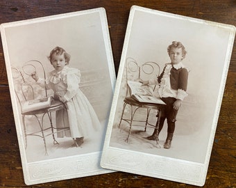 Pair of cabinet cards. Child posed with a book or photo album.