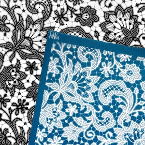 May include: A teal rectangular sheet featuring a white intricate lace pattern with floral and paisley motifs, with the word Paku printed in white script in the top left corner, layered over a black and white version of the same lace design.