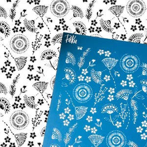 May include: Two sheets of patterned paper. One is white with black floral designs, the other is blue with white floral designs. The blue sheet has the word "Paku" in the upper right corner. The floral designs include stylized flowers and leaves.