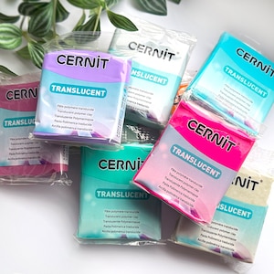 May include: A collection of Cernit Translucent polymer clay blocks in various colours including purple, white, blue, teal, pink, and beige. Each rectangular block is individually wrapped in clear plastic packaging with the brand name Cernit printed.